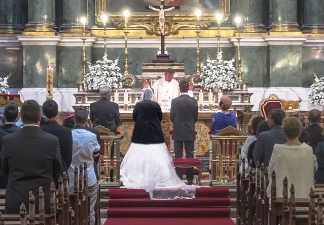 Priest forces bride to put on a coat to hide a large